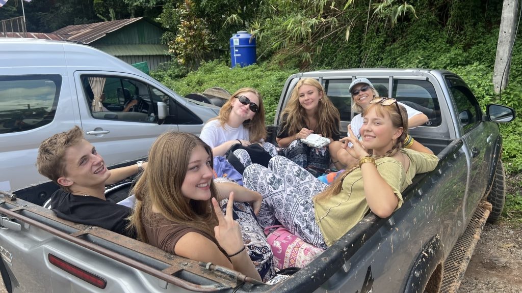 Rustic Pathways student travelers on the back of a pickup truck in Thailand.