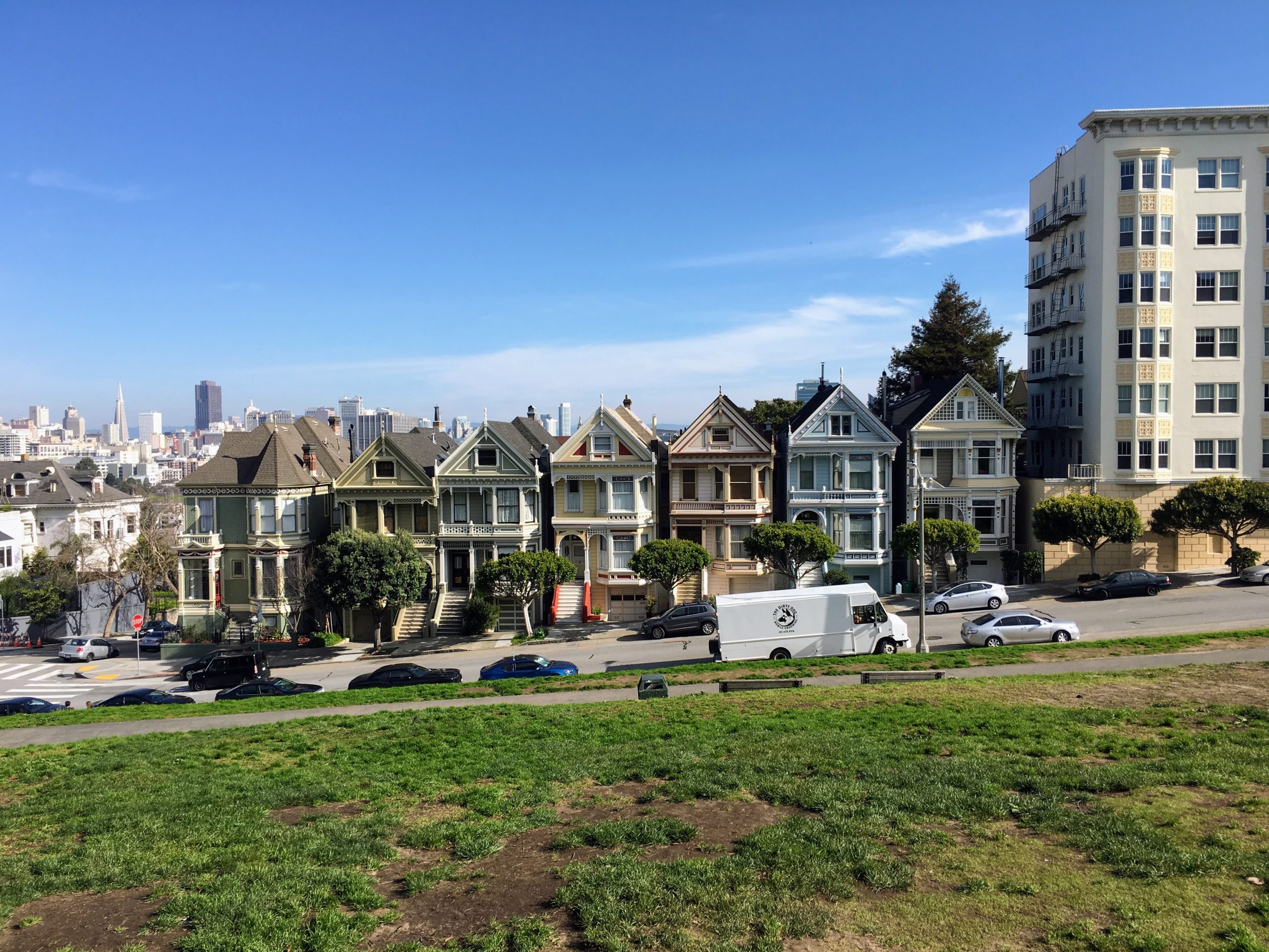 The iconic Painted Ladies houses in San Francisco with a city skyline in the background.