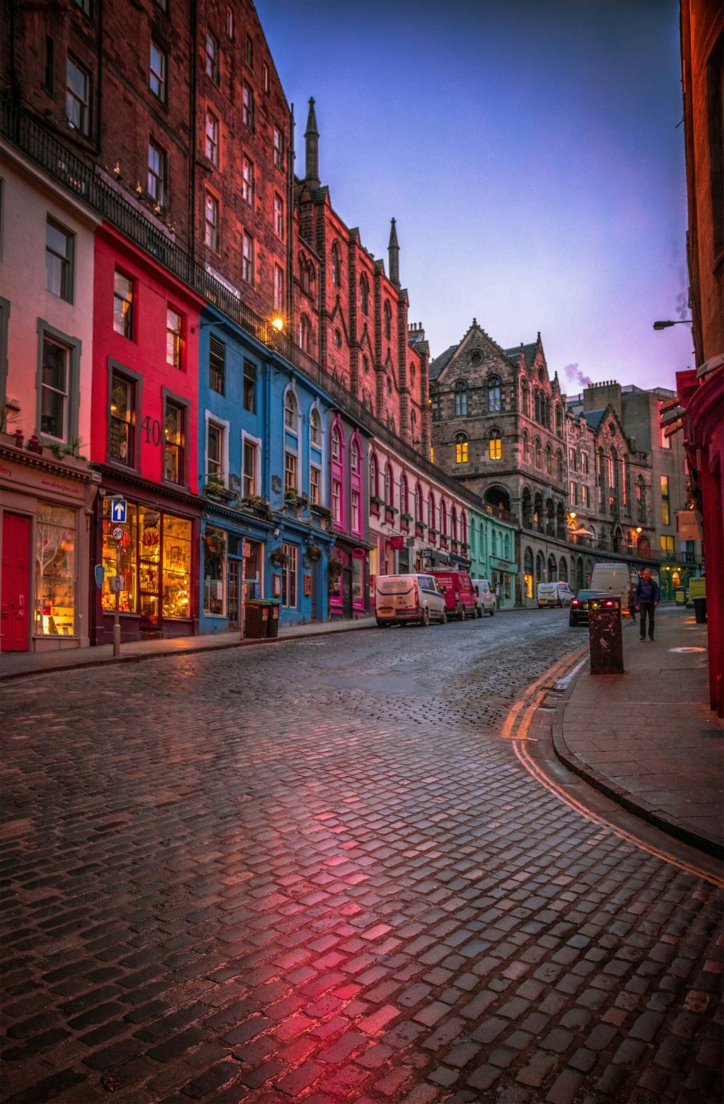 Picture of walkway and pavement in Edinburgh with colorful lights and buildings.