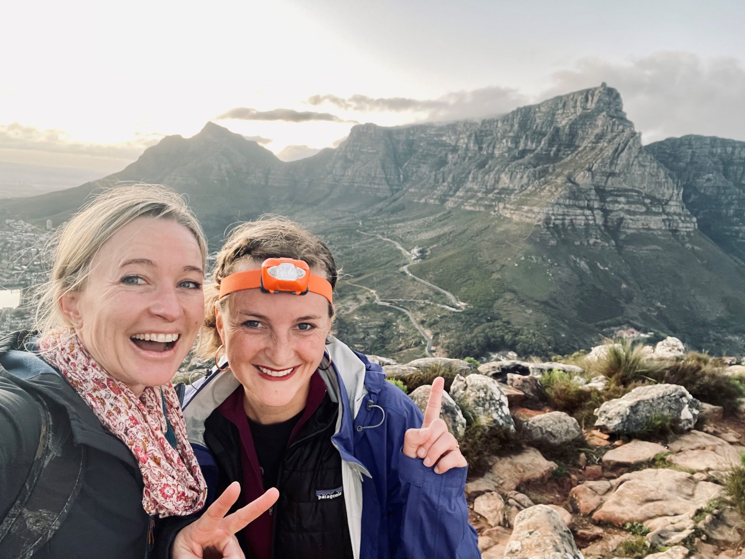 Students take a selfie atop Table Mountain with rugged peaks behind them