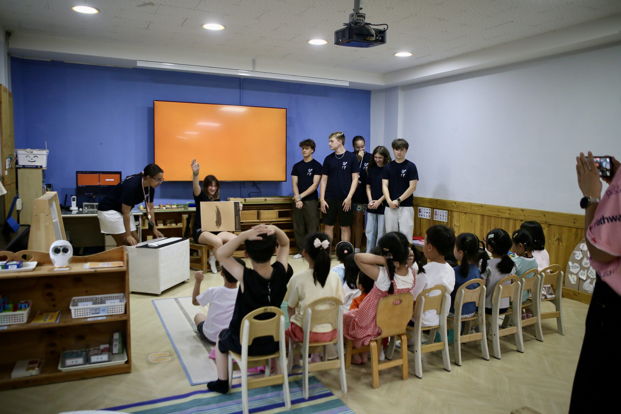 Student travel vs internships: a group of student travelers teaching in a classroom on a student travel program