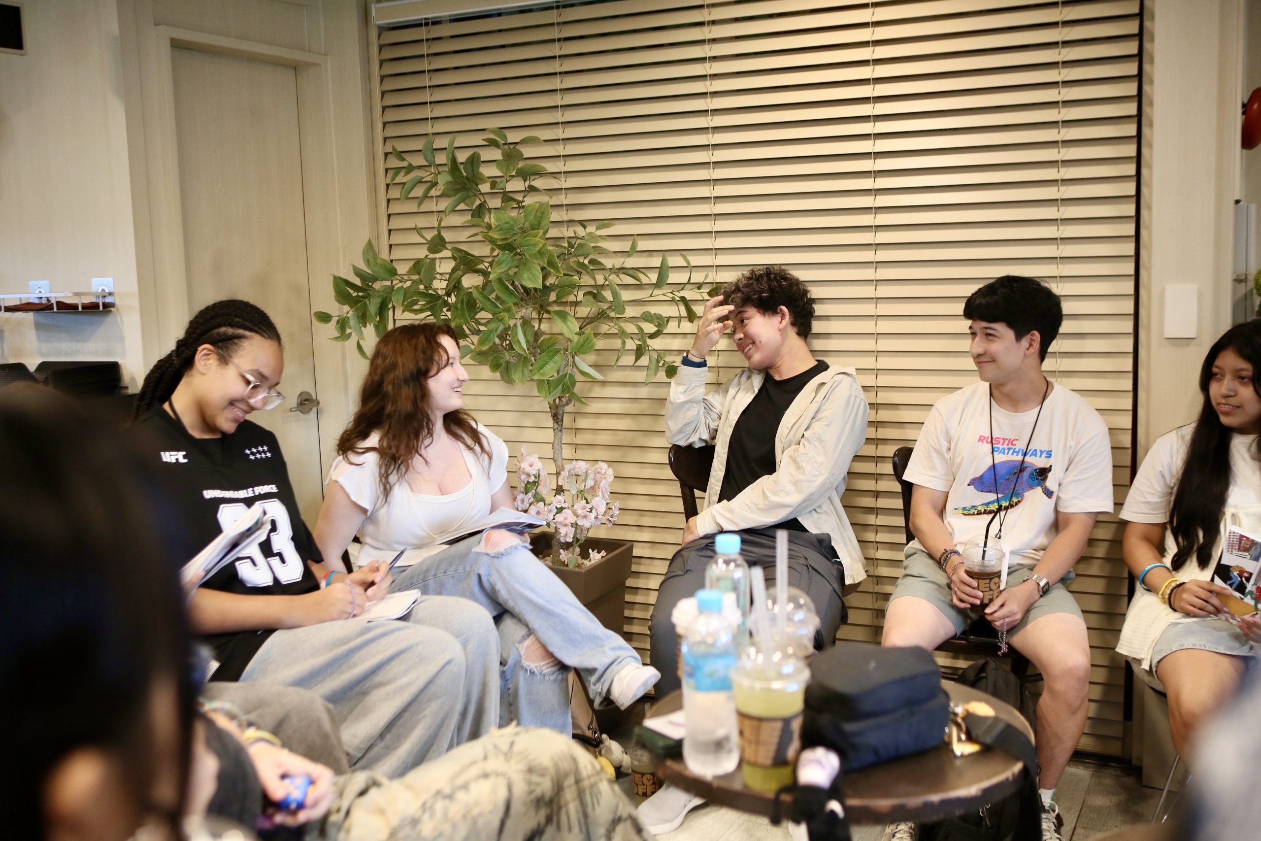 Student Travel vs College: a group of students sitting in a circle reflecting during their student travel program in Korea.