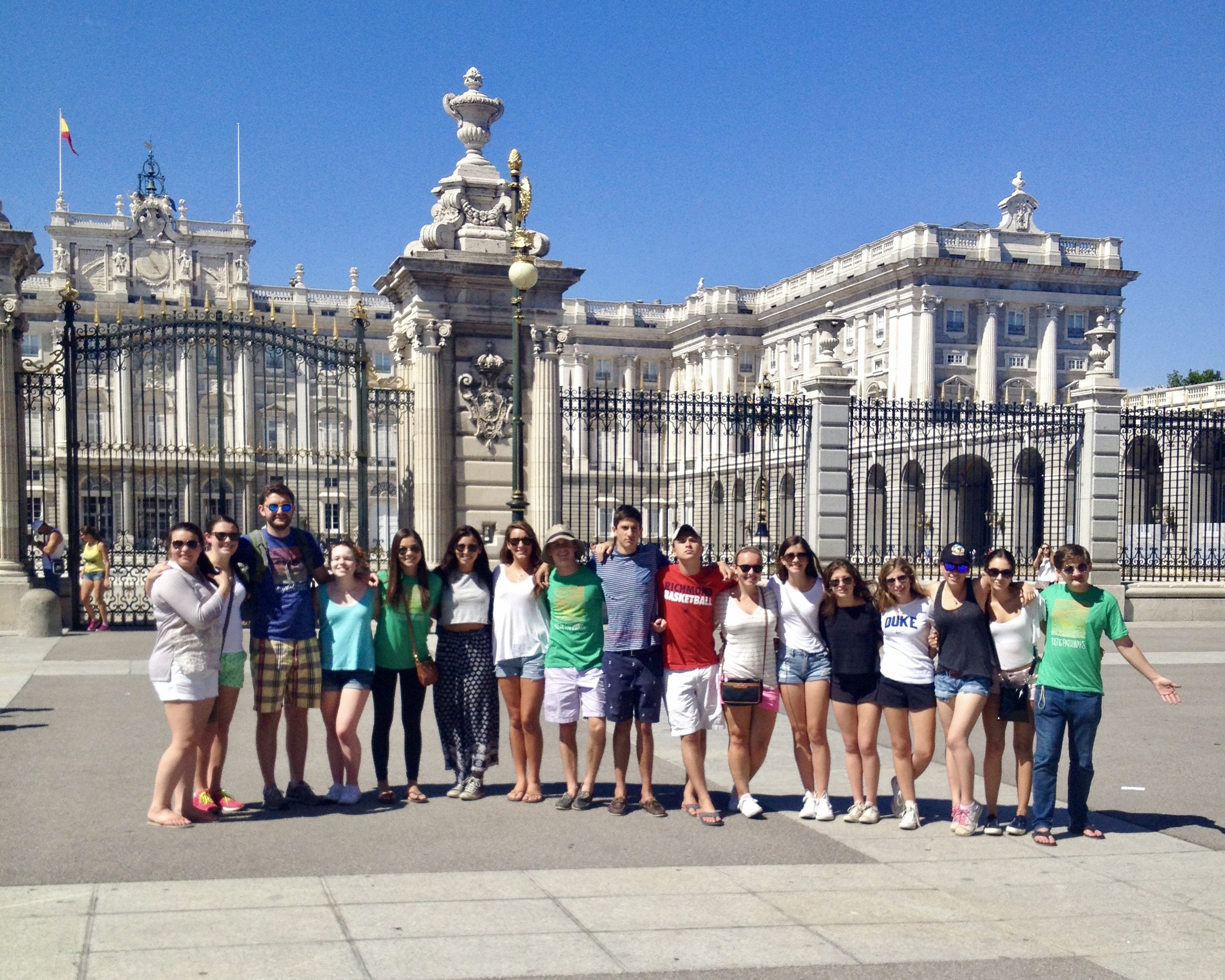 Student travelers pose together outside the gates of Madrid's Royal Palace