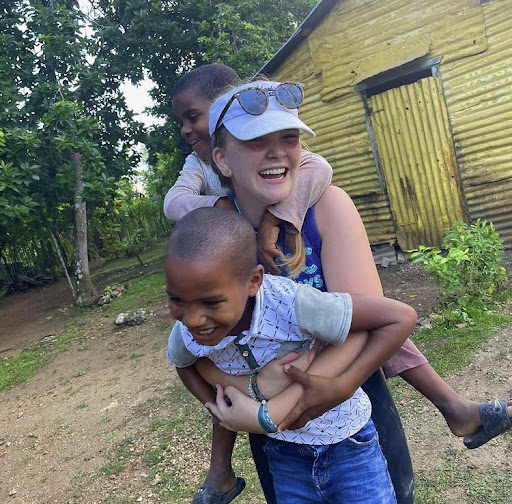 Sydney Roach playing with children in the Dominican Republic