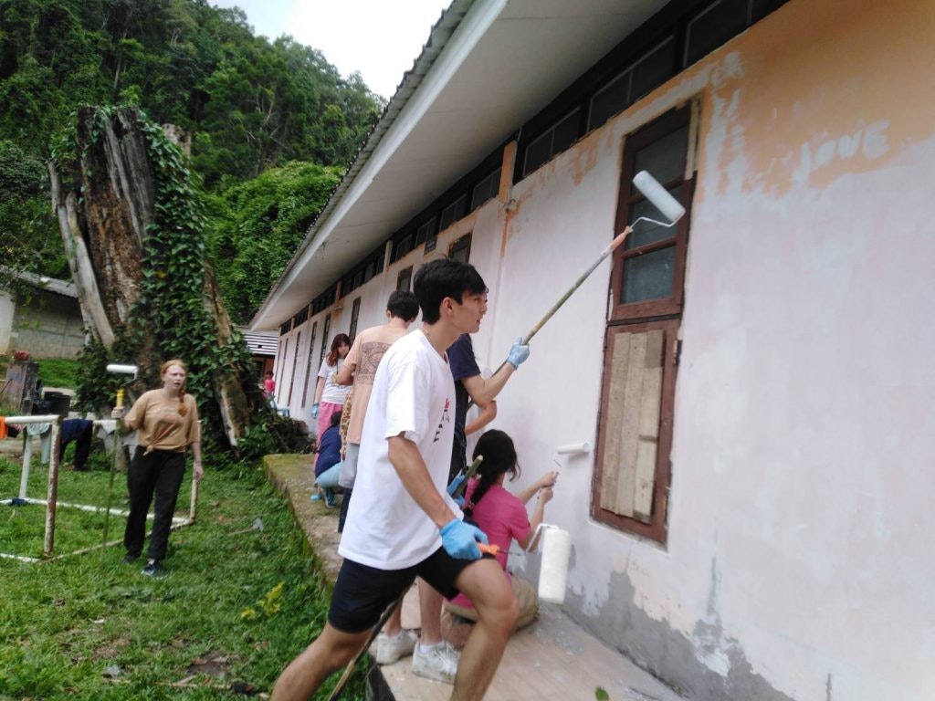 Rustic Pathways students paint a school in a remote village in Thailand.