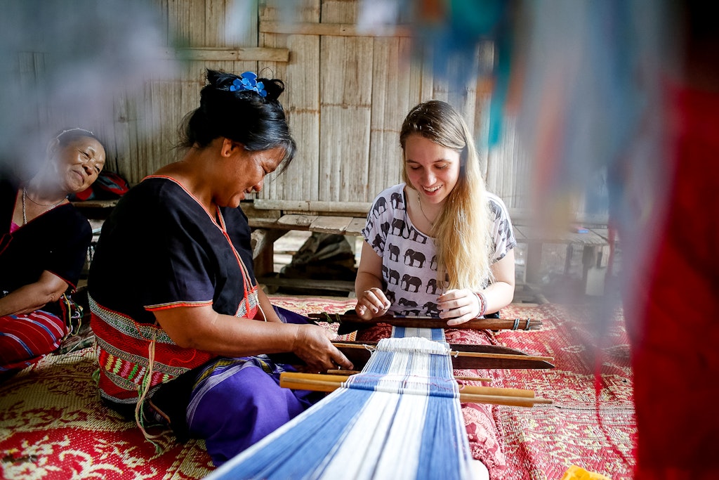 A student learns how to make a rug from professionals in Thailand.