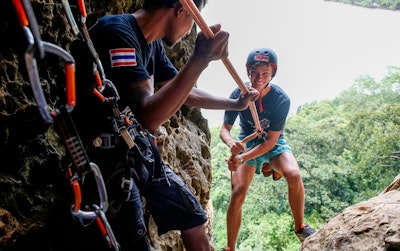 Adventure teen tour student abseiling in Thailand with a professional guide.
