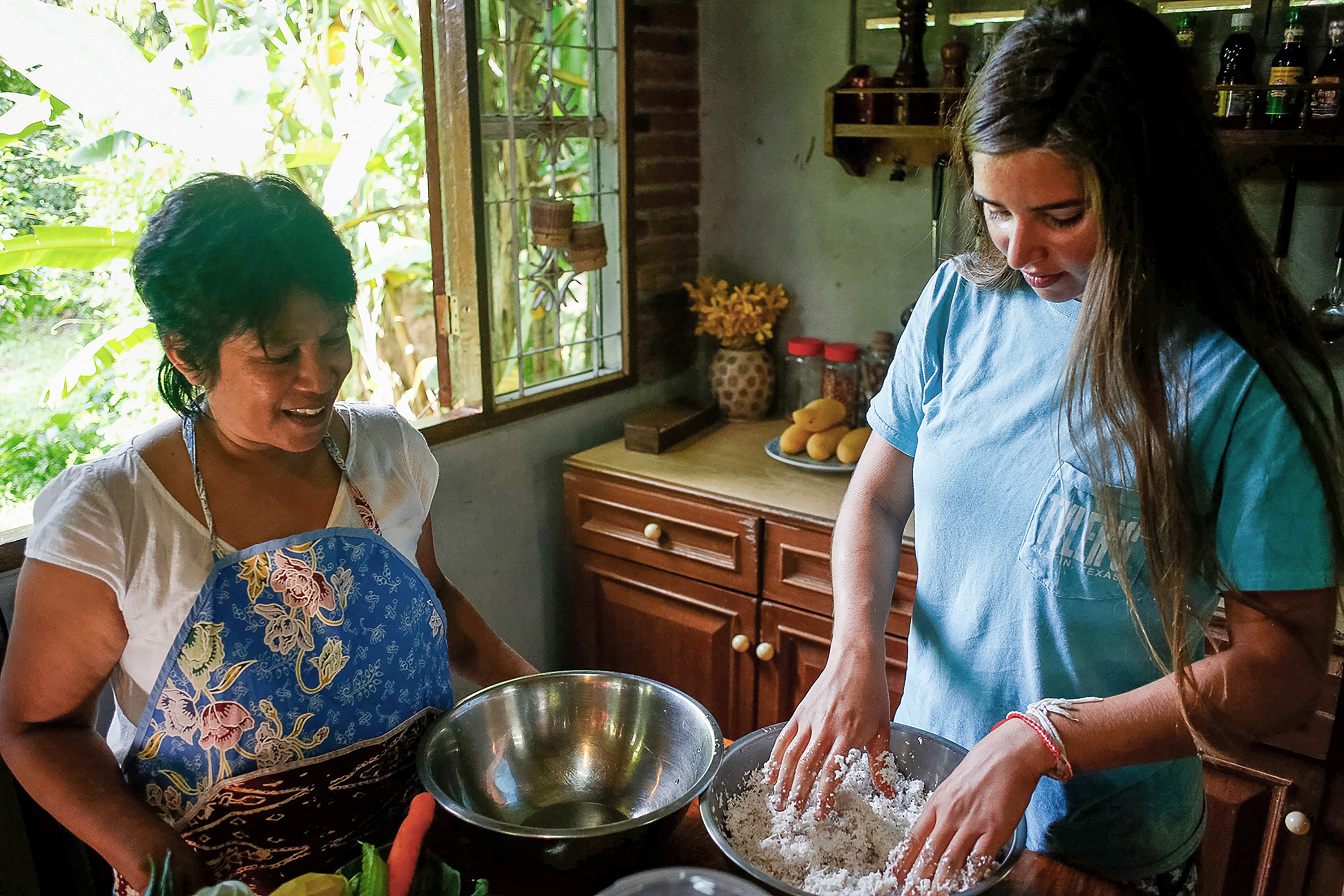 Two people preparing dish in Thailand in the kitchen.