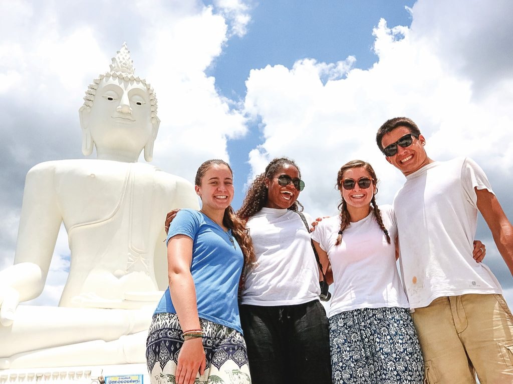 A group of students visiting a temple in Thailand on an adventure teen tour abroad