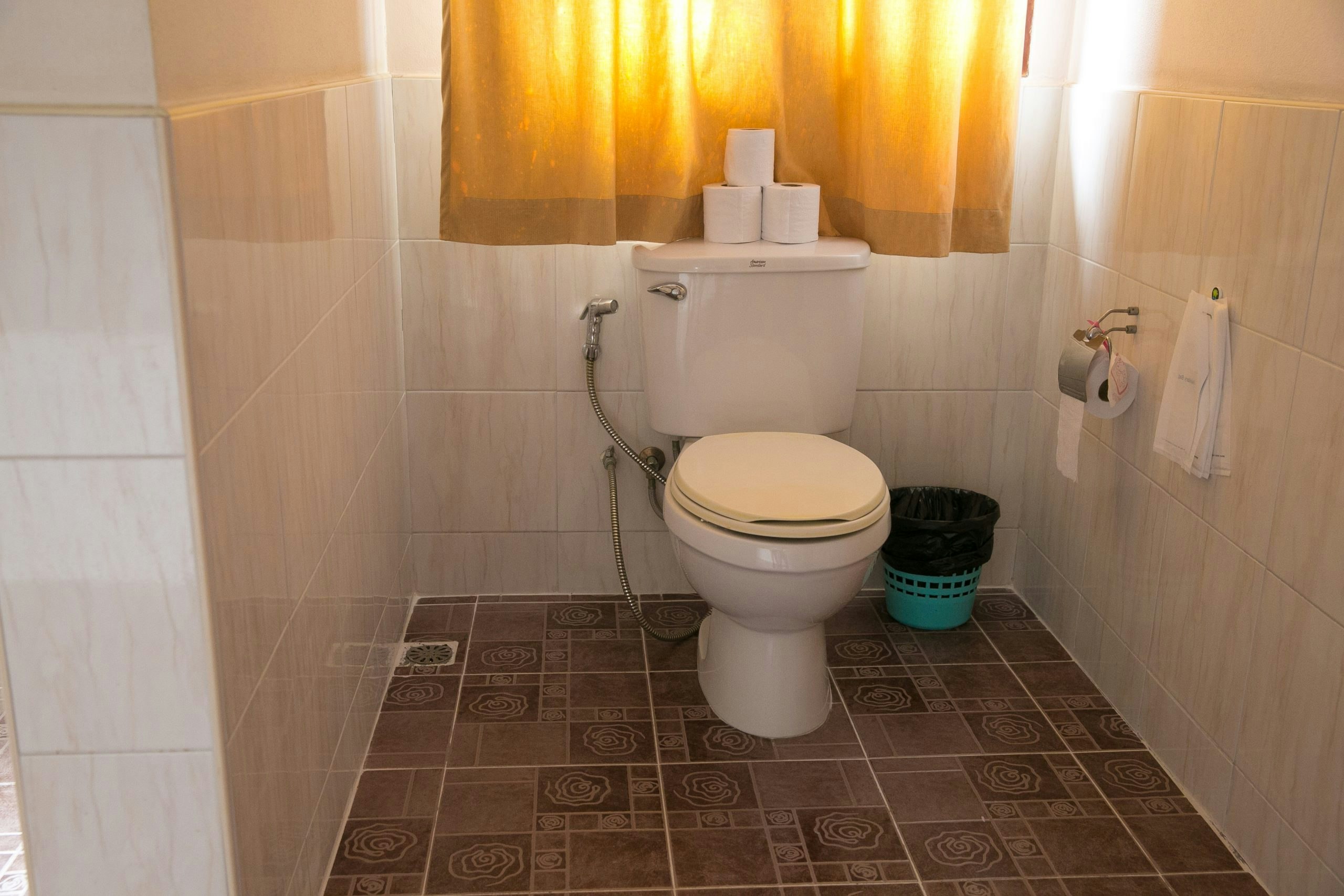 Shared bathroom area with clean tiled surfaces at a Thailand base house for students.