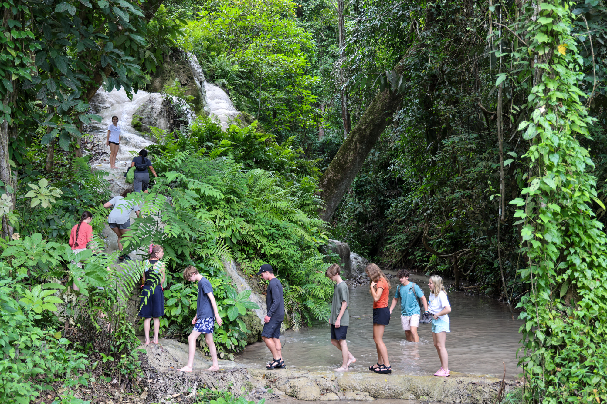 Students hiking up mountain in Thailand.