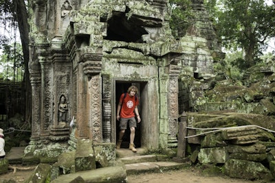 a student traveler explores an ancient temple in Thailand during a teen tour.