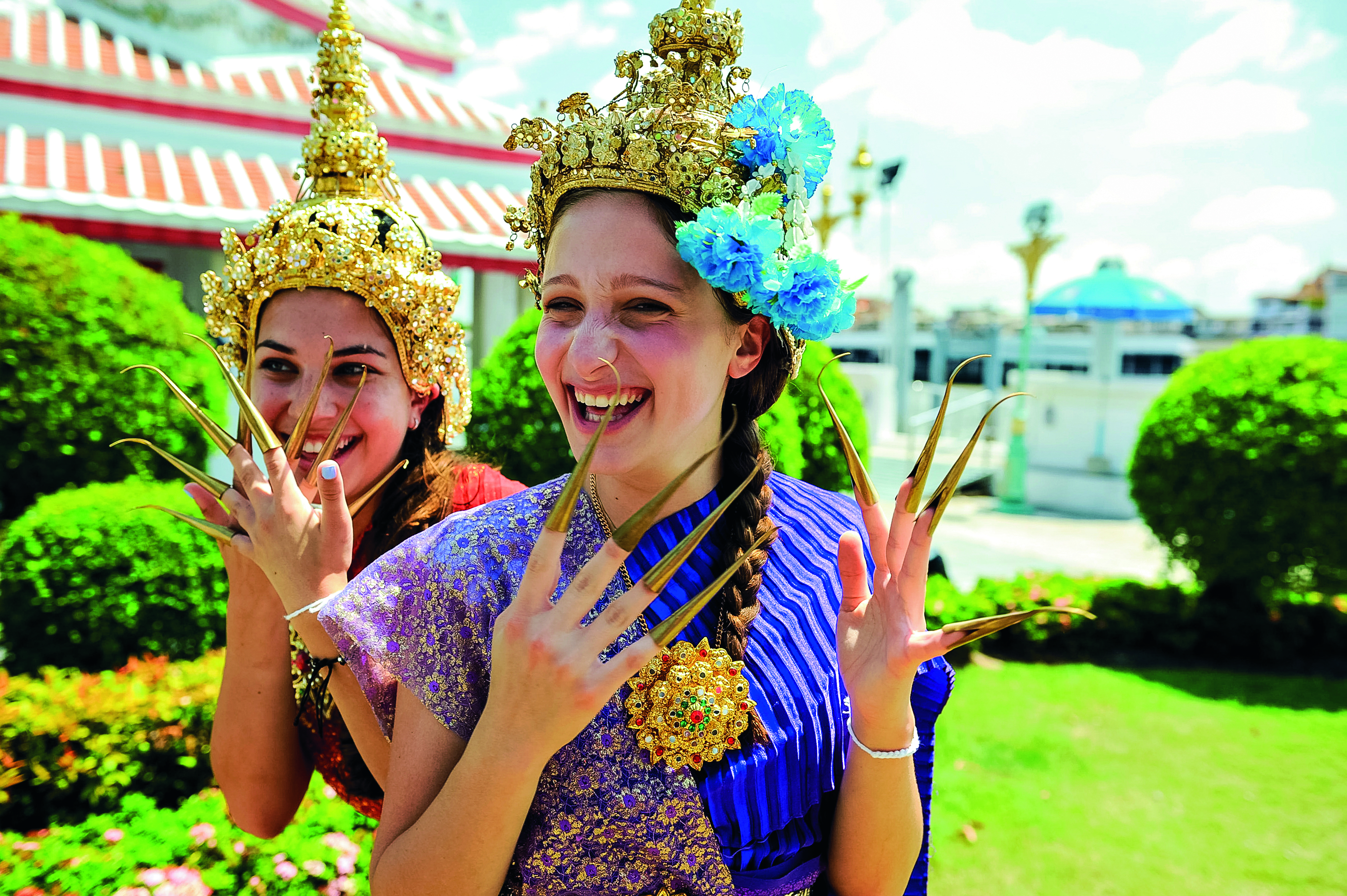 Teen student hammering during construction service project in Thailand