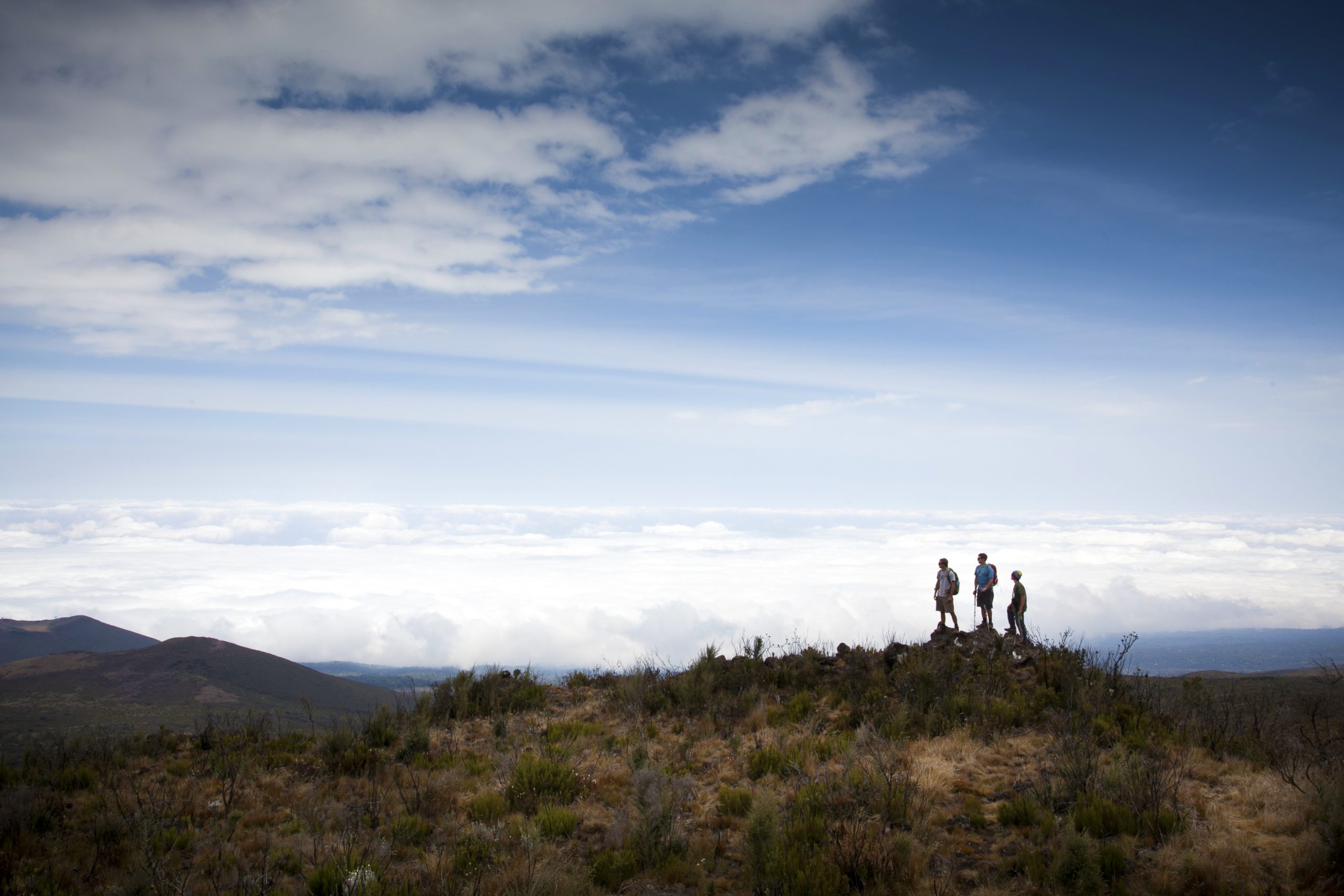 Students stand atop a ridge above a sea of clouds on Mount Kilimanjaro in Tanzania