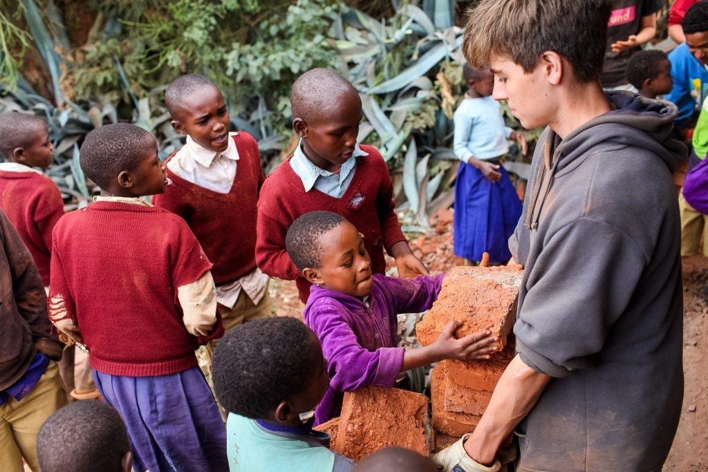 Students help locals on a program.