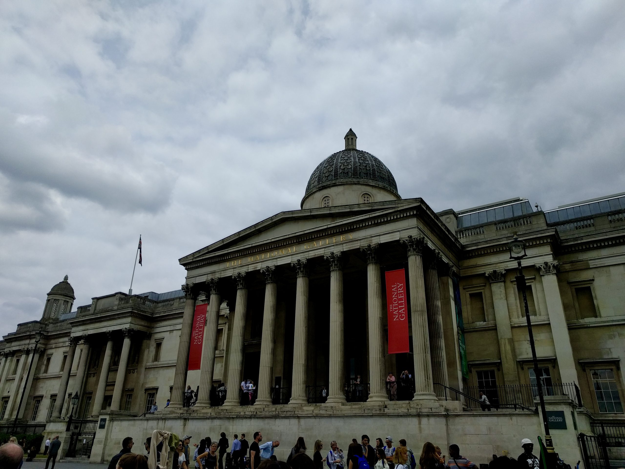 Teens gather outside the National Gallery's columned entrance under a cloudy sky