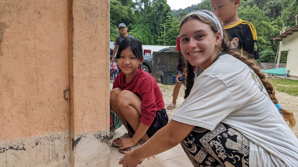 Rustic Pathways students work on school projects with children in Thailand.