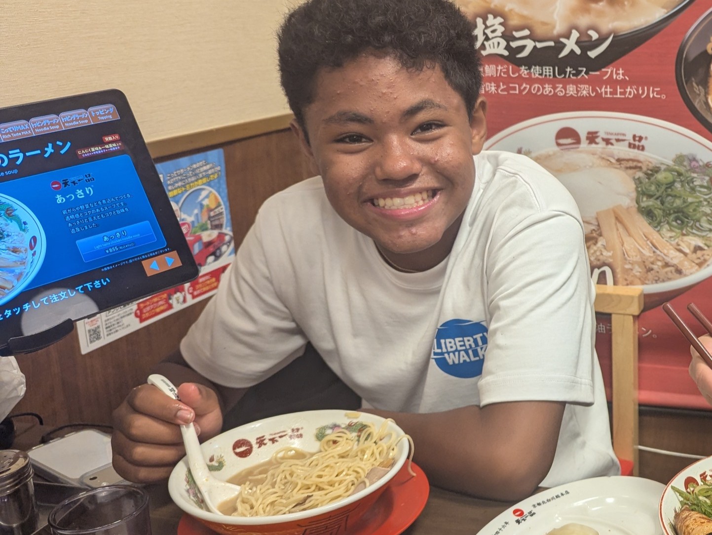 A student eating ramen at a restaurant in Japan