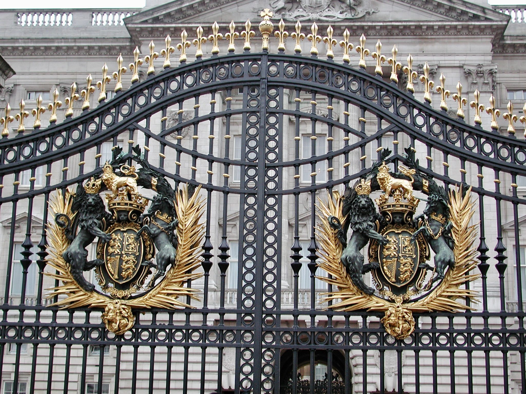 The gilded royal crest on the ironwork gates of Buckingham Palace