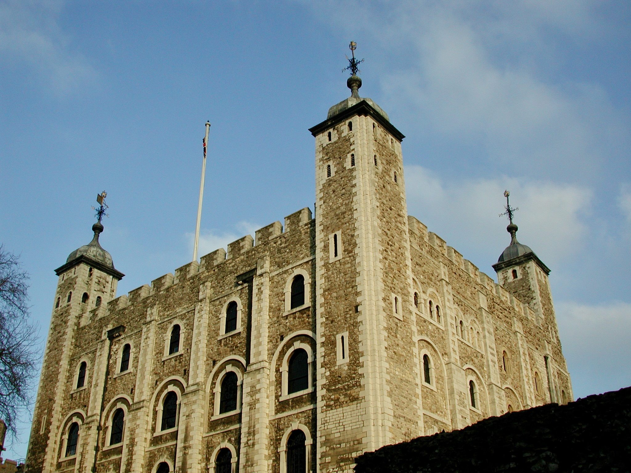 The White Tower at the Tower of London, its corner turrets against a clear sky