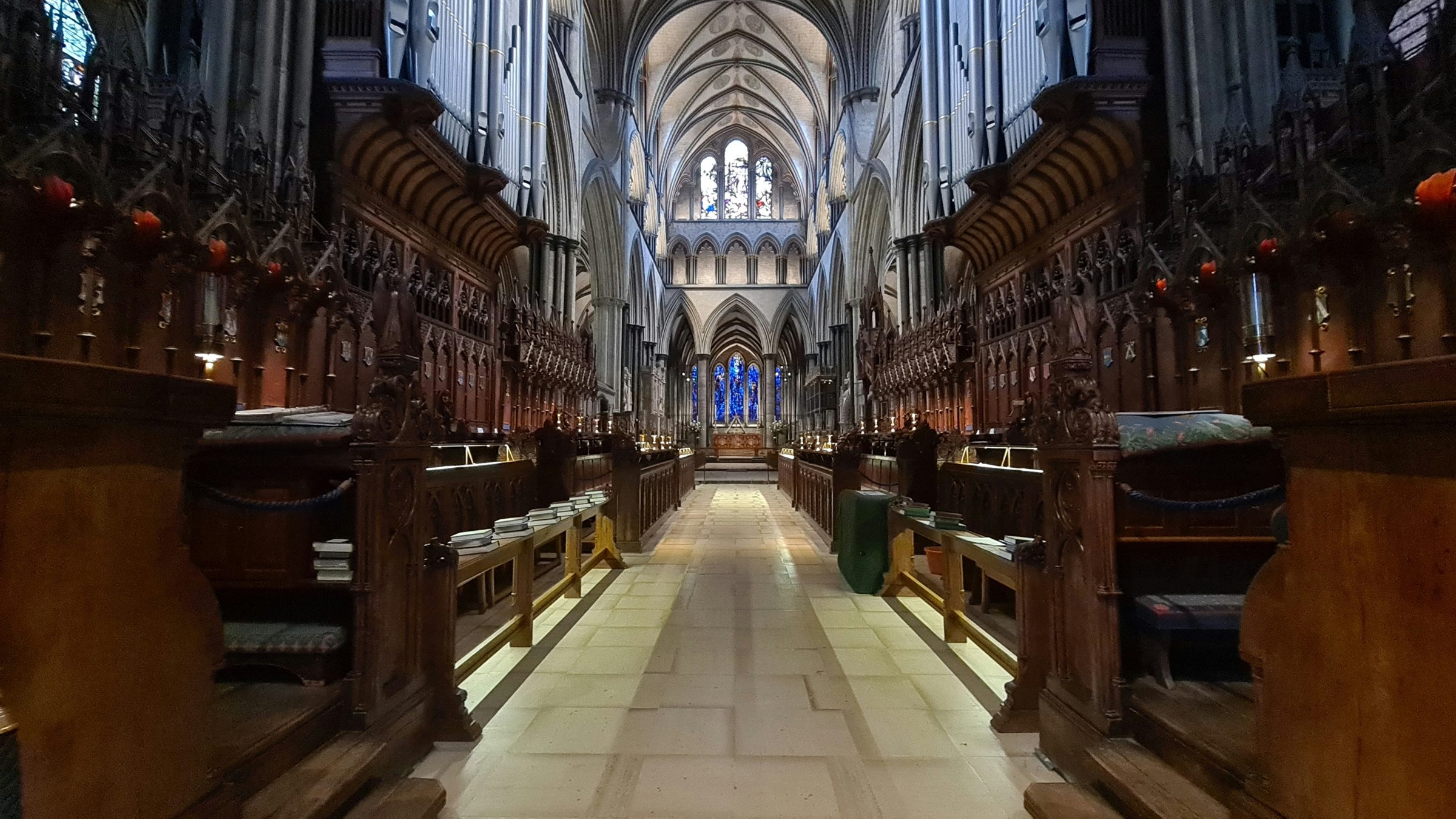 The nave of Salisbury Cathedral looking east between carved choir stalls
