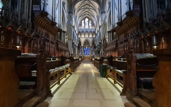 The nave of Salisbury Cathedral looking east between carved choir stalls