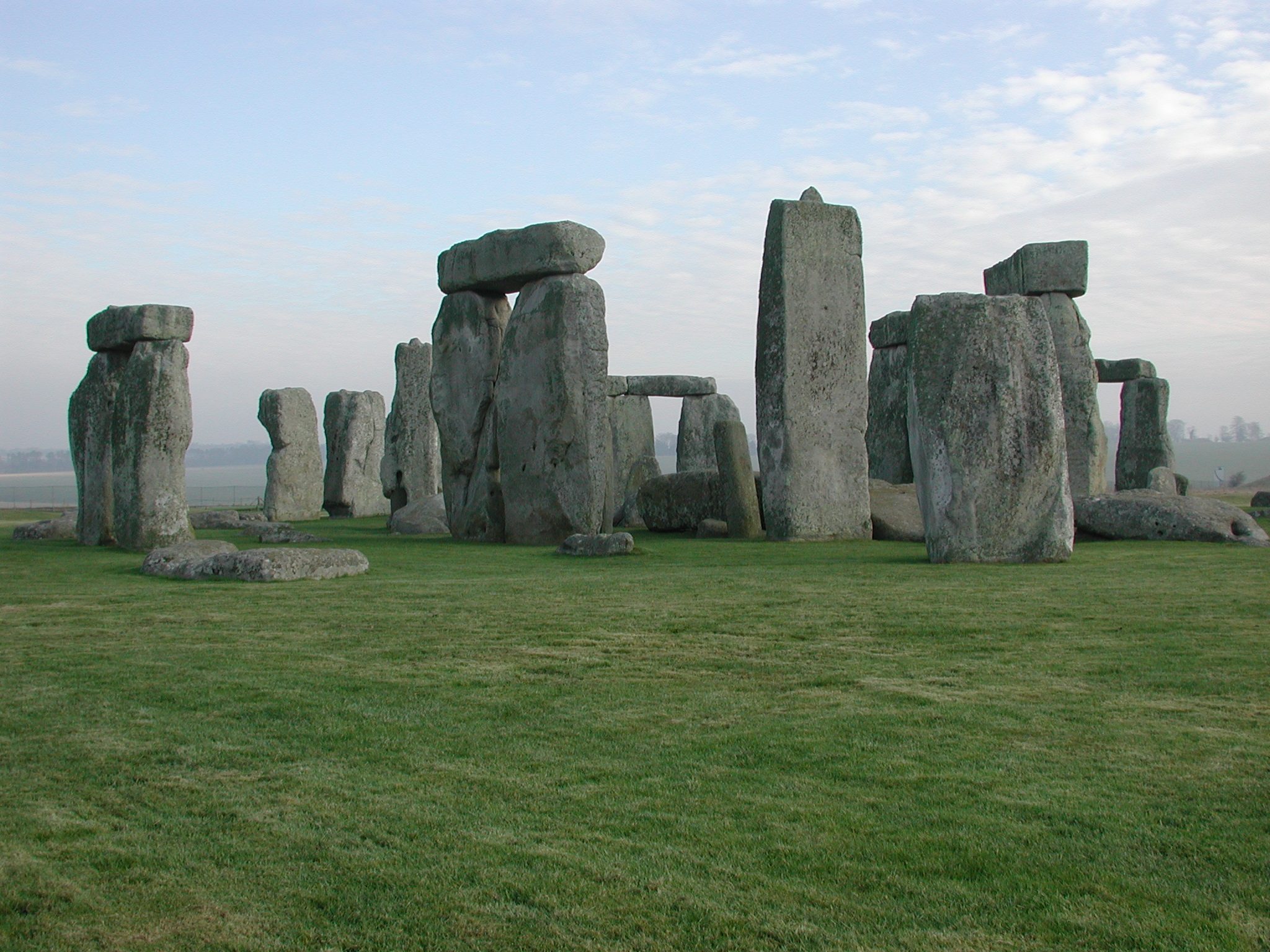 The standing stones and lintels of Stonehenge on open Wiltshire grassland