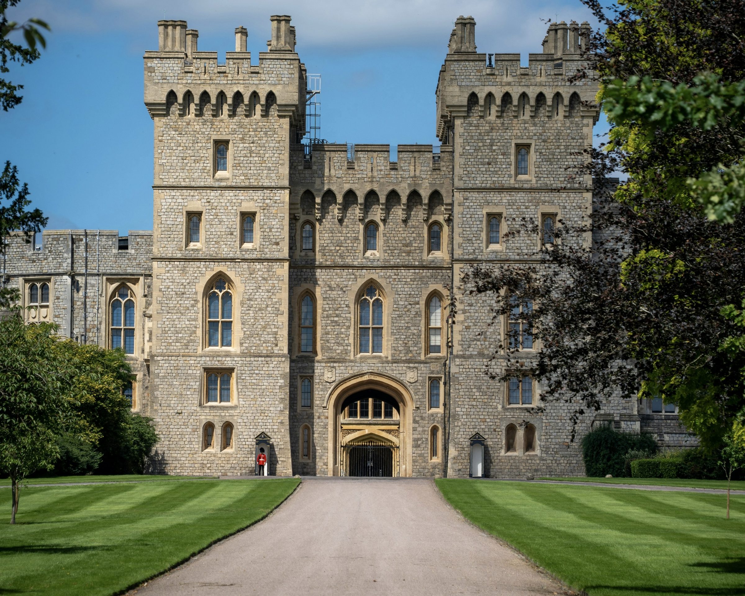 The gatehouse towers of Windsor Castle at the end of a lawned approach