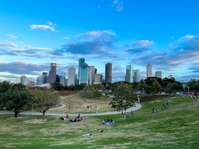 The lawn at Hermann Park with the Houston skyline beyond.
