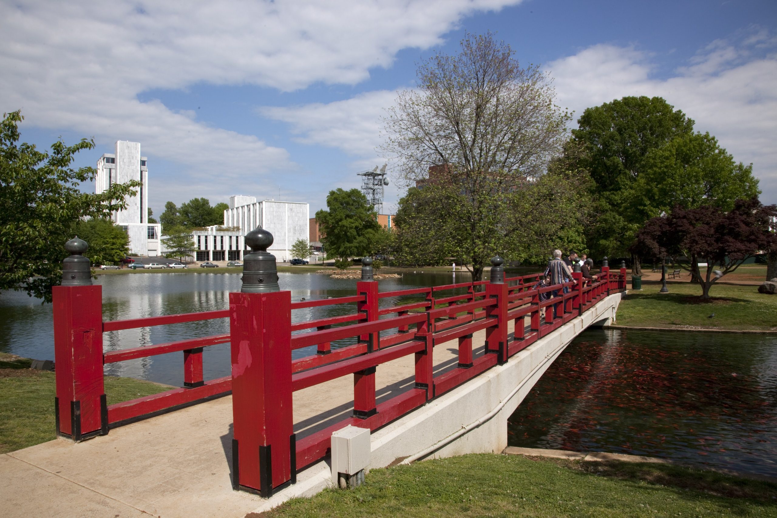 The red bridge over the lagoon at Big Spring Park, with downtown Huntsville behind it.