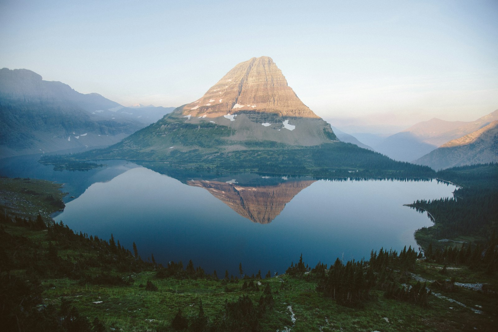 A lake below the peaks of Glacier National Park.