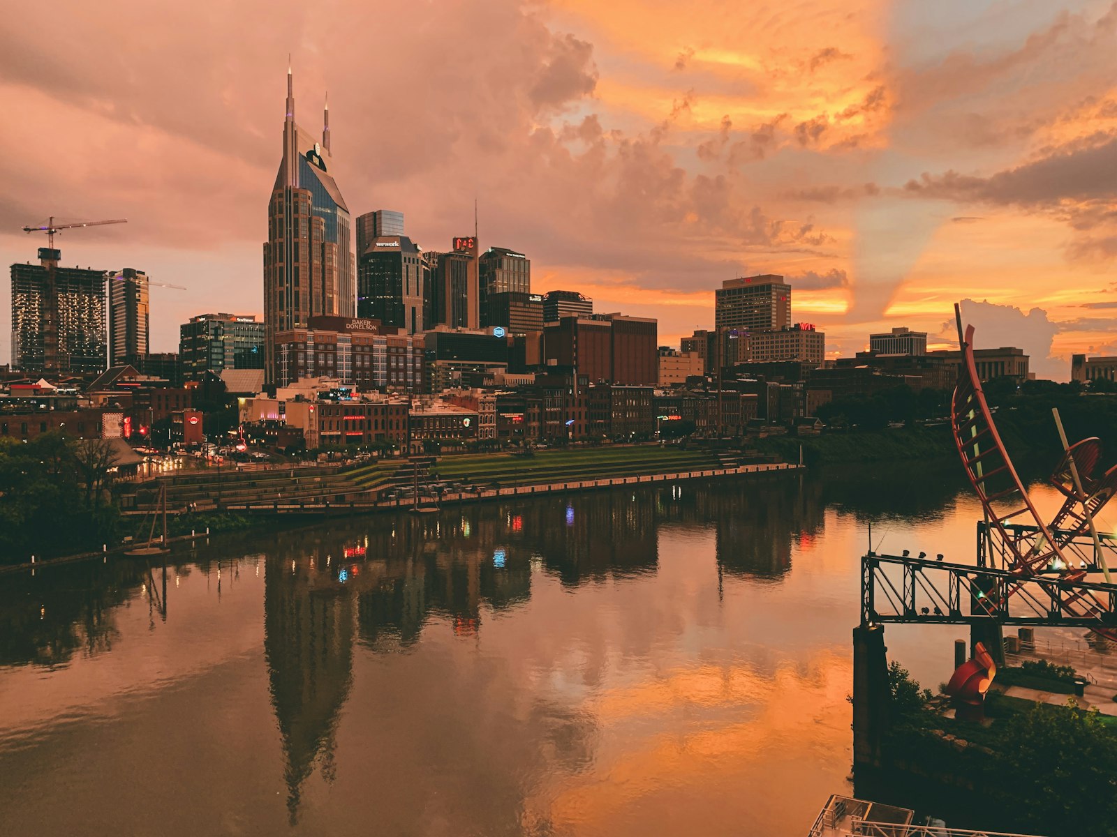 The Nashville skyline across the Cumberland River at sunset.