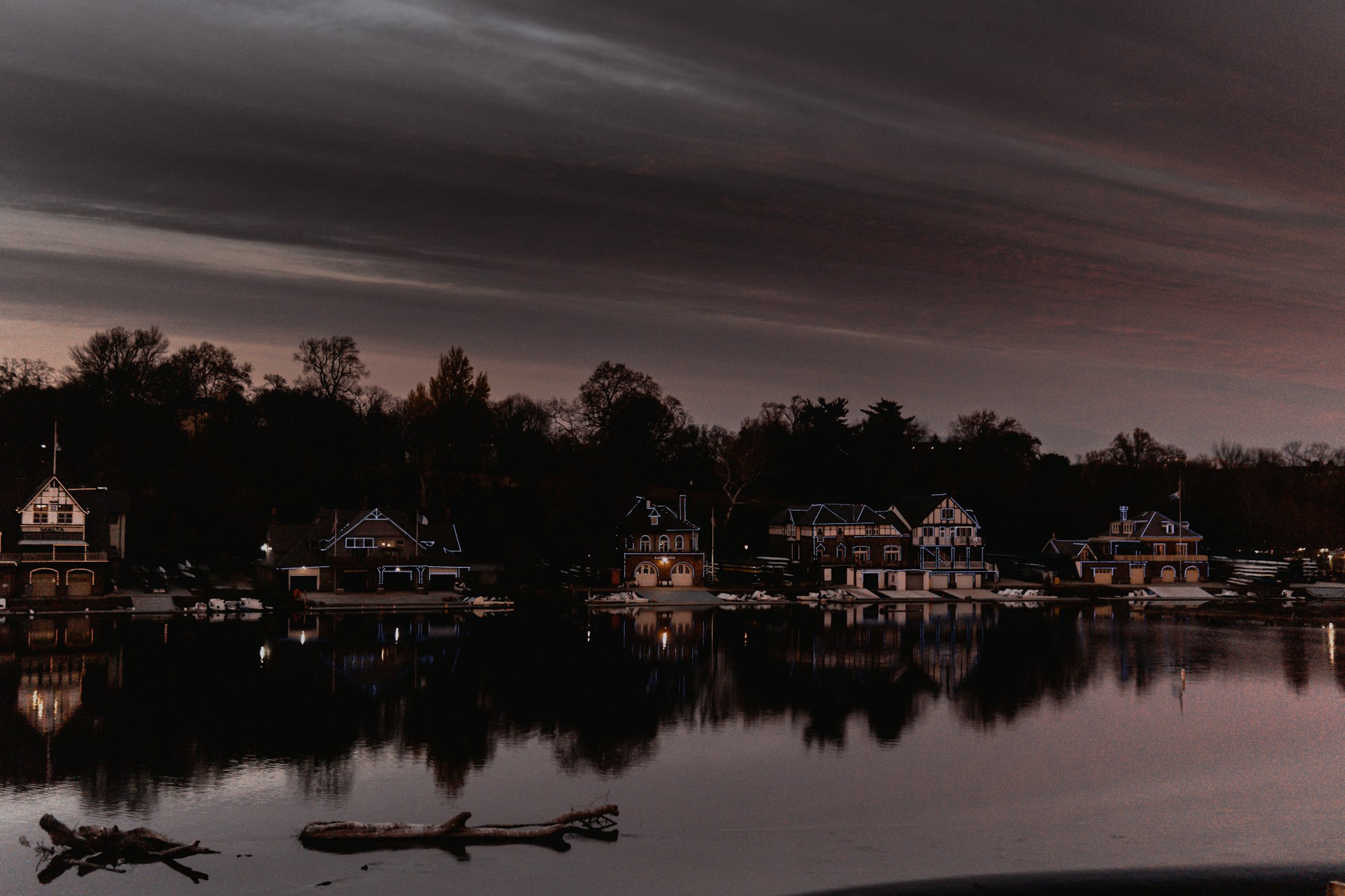 Boathouse Row illuminated beside the Schuylkill River in Philadelphia.