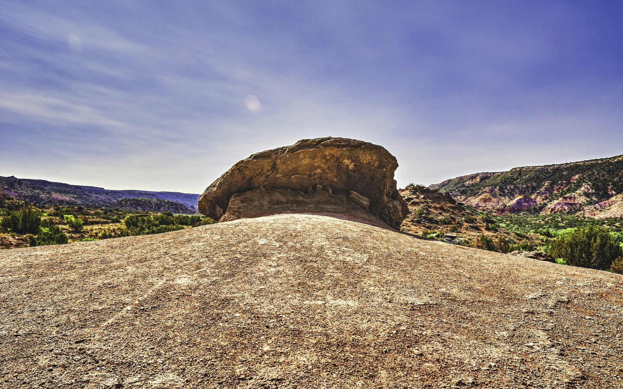 A weathered granite boulder and the surrounding landscape at Enchanted Rock.