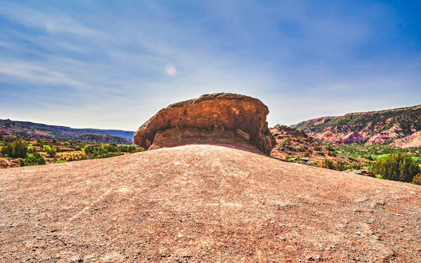 A weathered granite boulder and the surrounding landscape at Enchanted Rock.
