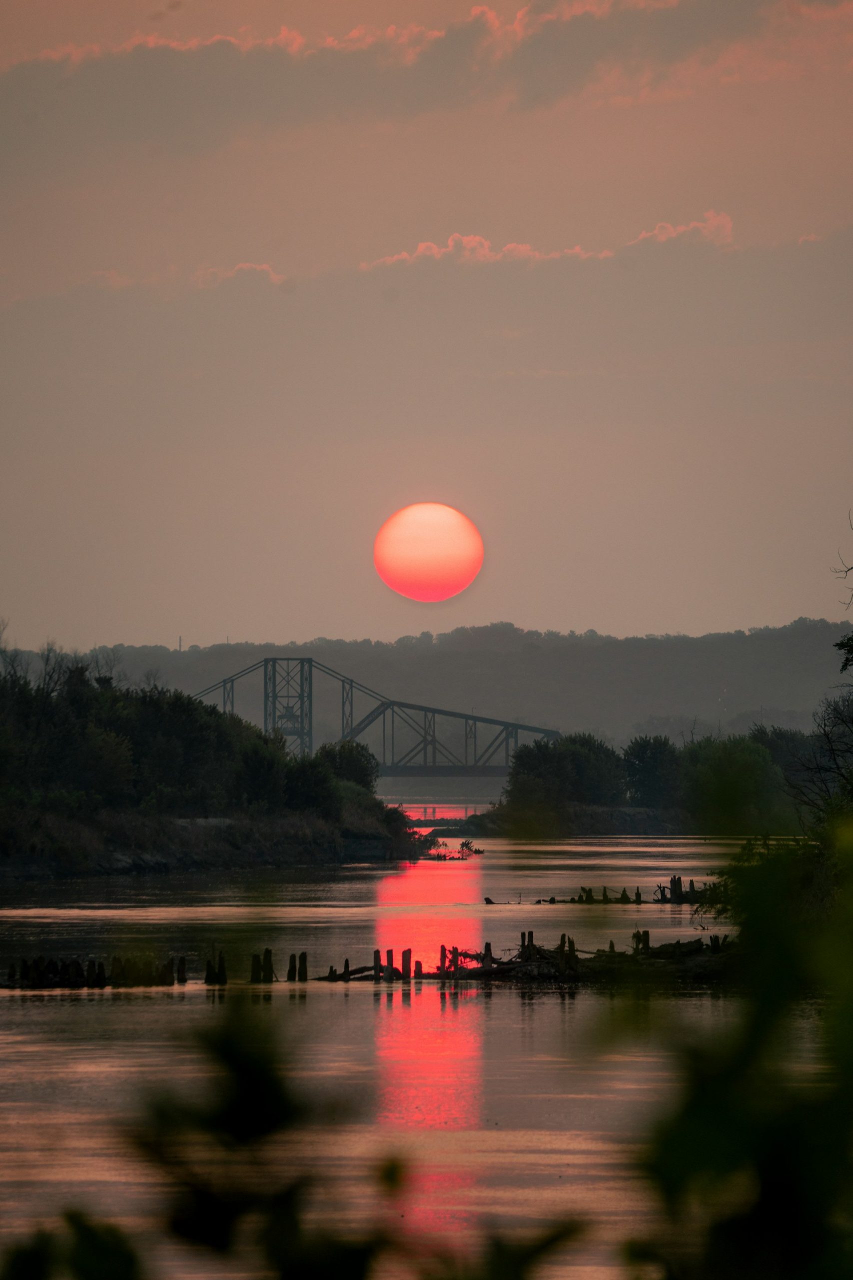 A low sun over a river bridge in Missouri.