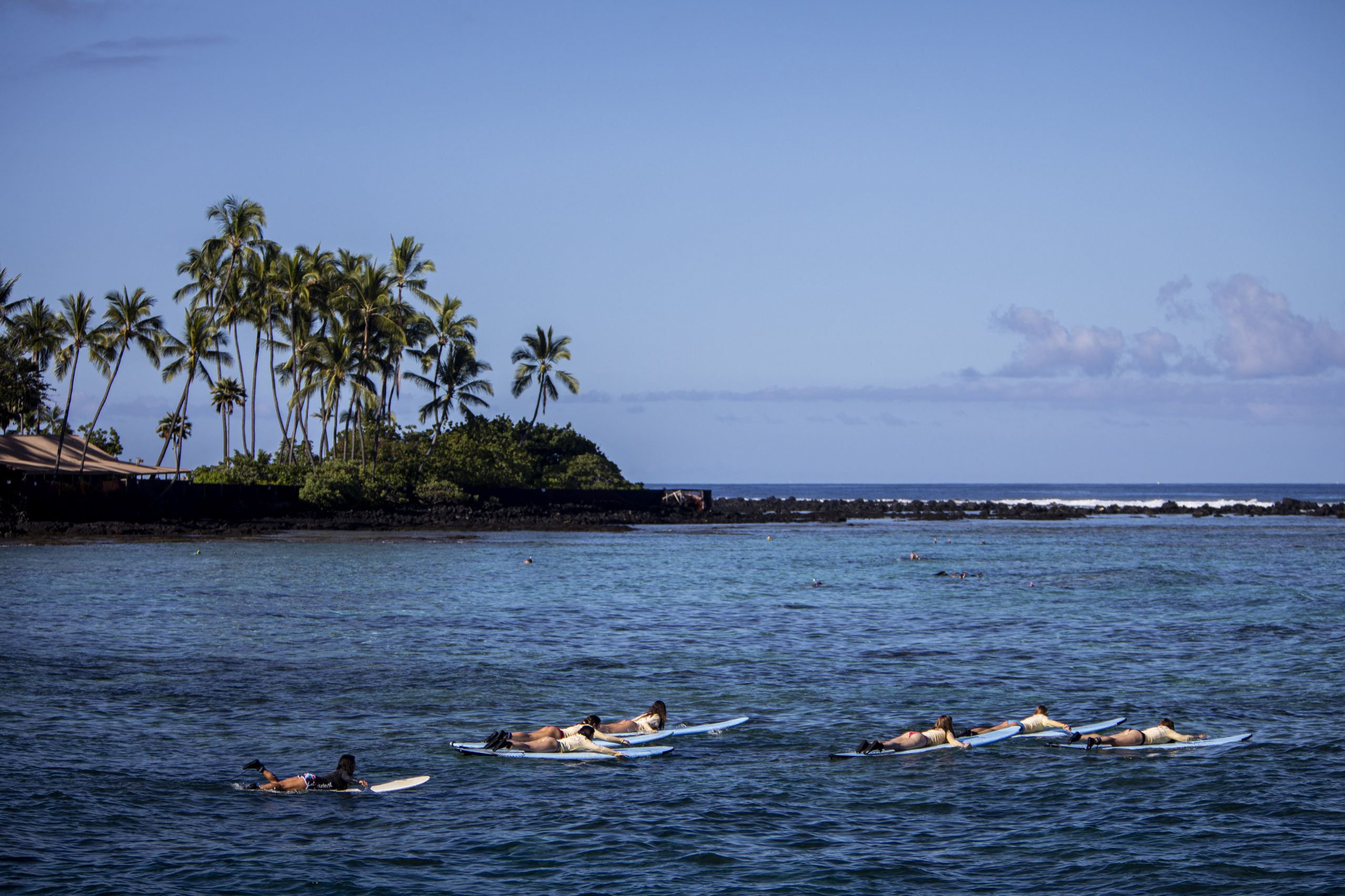 Photo of the ocean in Hawaii with a view of some land with trees.