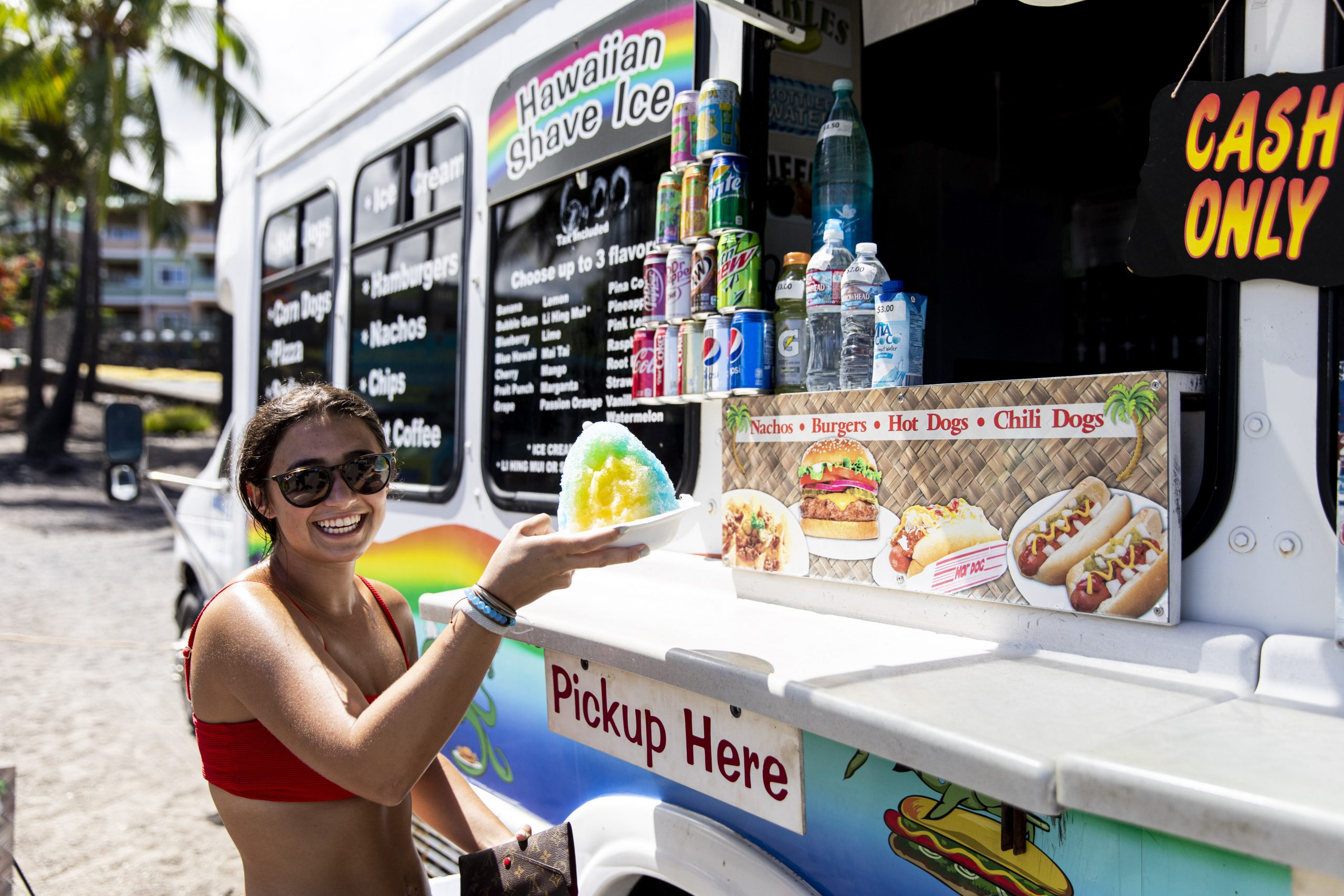 Photo of girl receiving shaved ice from food truck in Hawaii.