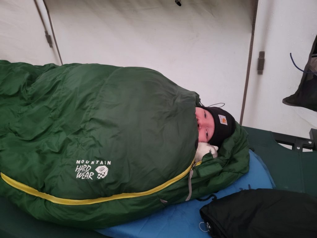 A Rustic Pathways students keeps warms in a sleeping bag in Alaska. 
