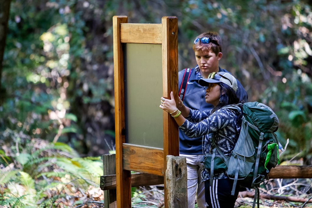 Two campers are looking for the right way in a park.
