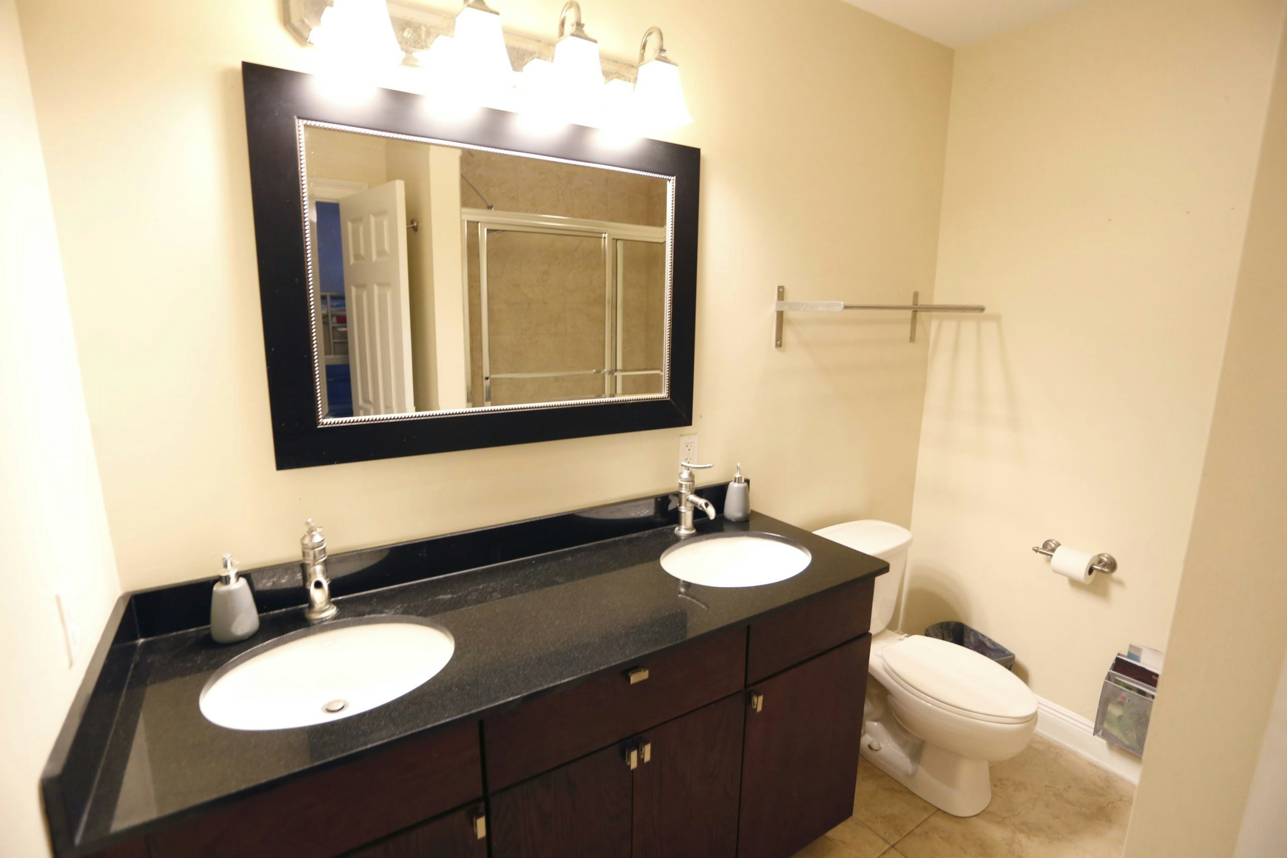 Well-maintained bathroom with standard toilet and sink at a student accommodation in New Orleans, USA.