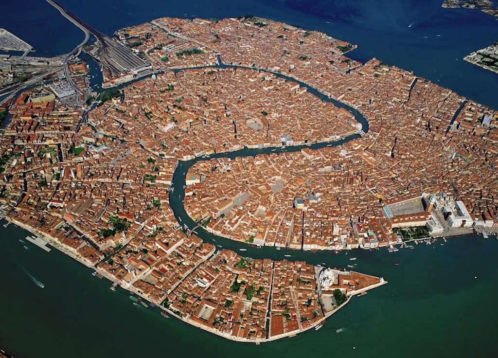 What is the Grand Canal in Venice? Aerial view of the old town island of Venice and its surrounding lagoons.