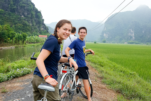 fun facts about vietnam. Tourists on bicycles exploring the picturesque rural landscape of Vietnam.