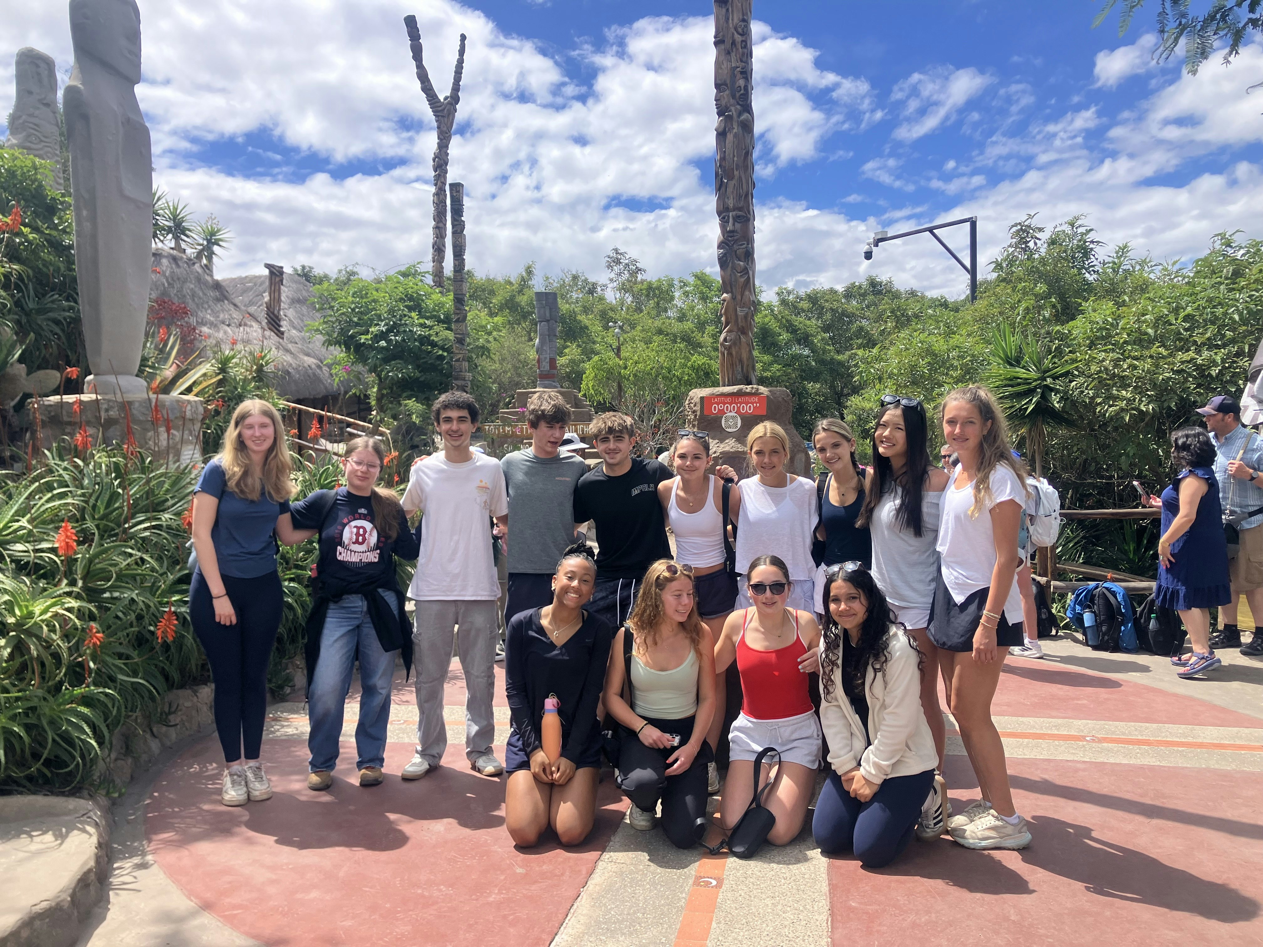 2025 Wild Galápagos students standing at the Middle of the World monument in Quito, Ecuador