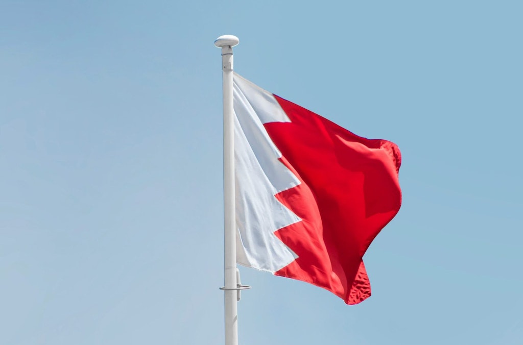 The flag of Bahrain waves in the wind.