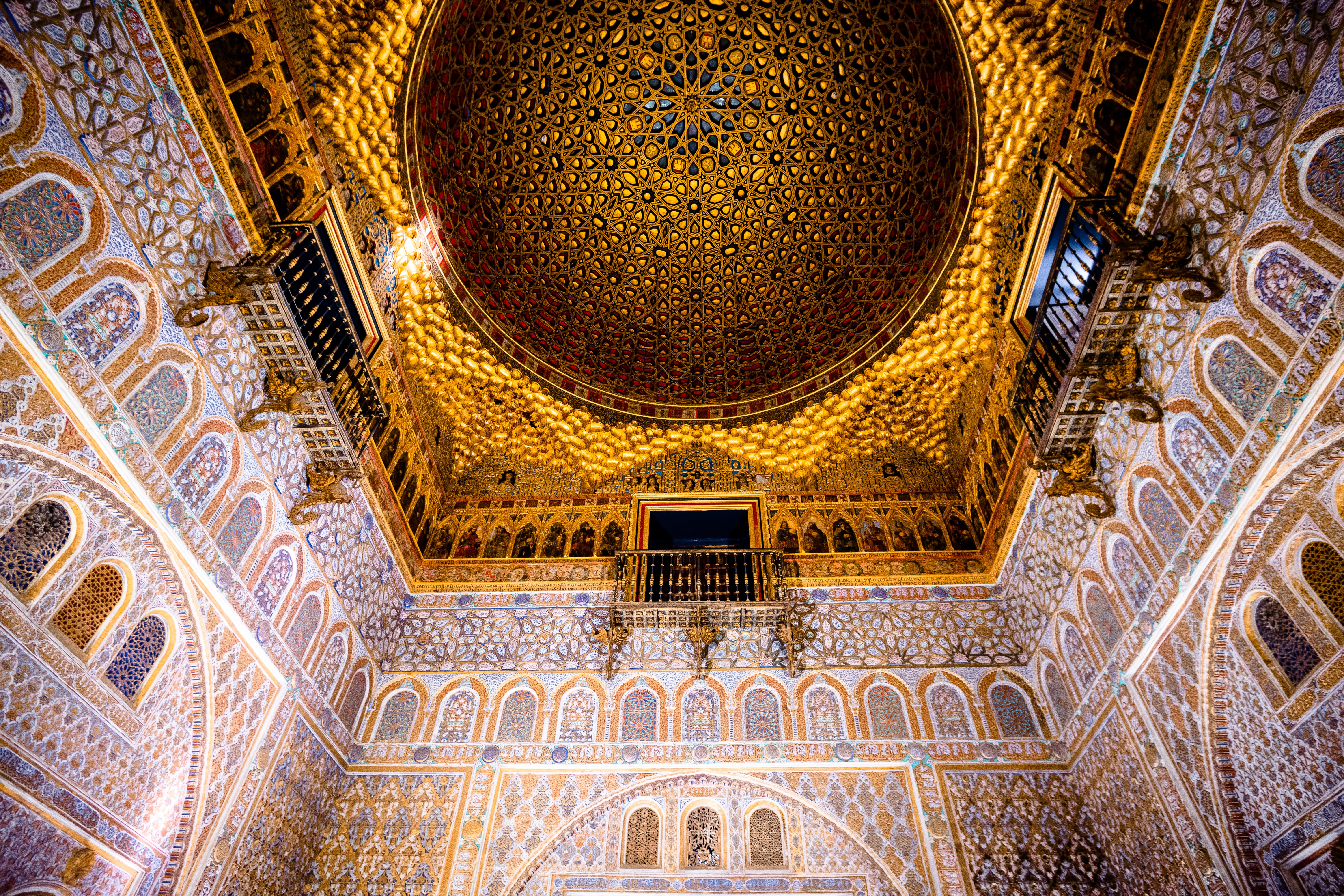 Ornate gilded dome ceiling with intricate Moorish tilework and carved arches