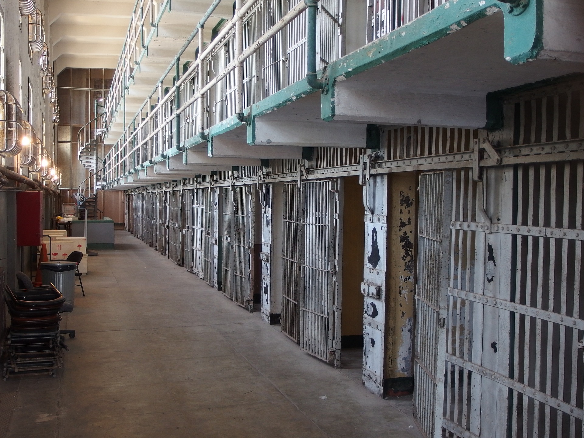 Rows of empty cell doors line a corridor inside Alcatraz prison