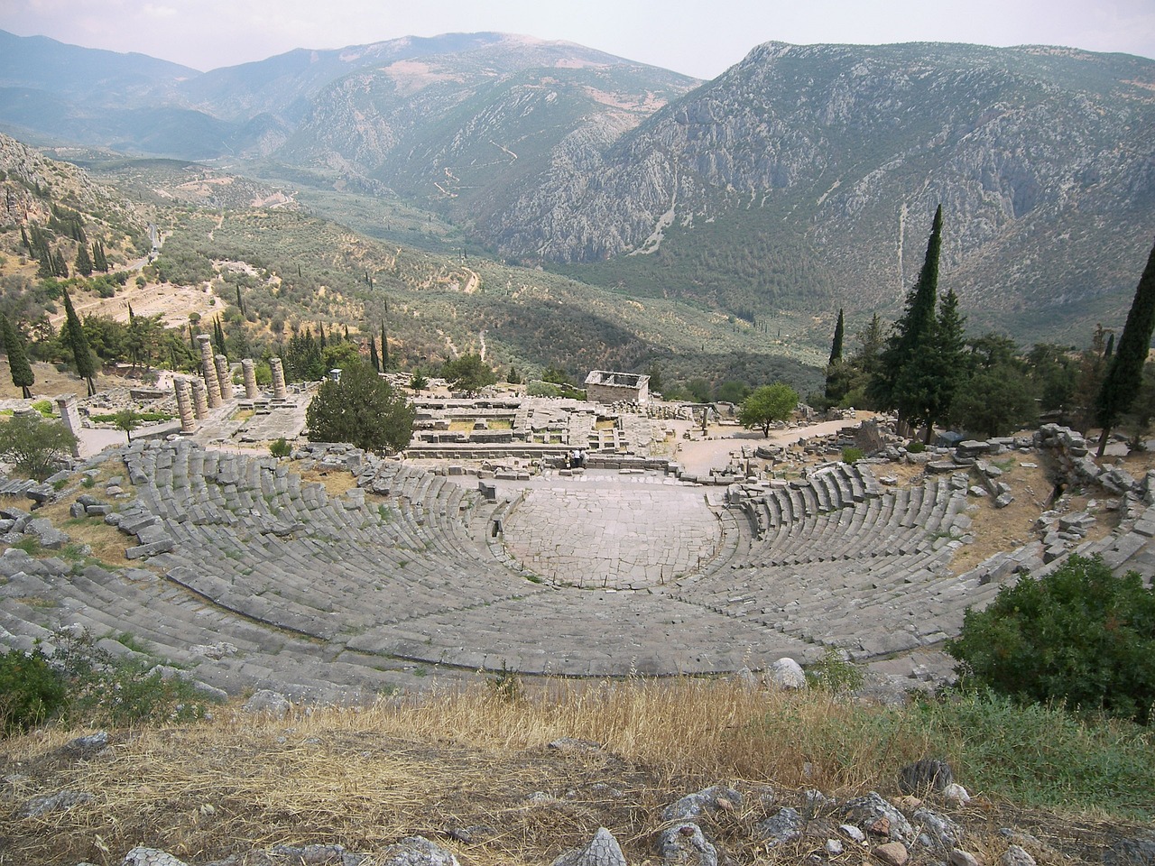 Ancient stone amphitheater ruins nestled in a mountainous valley