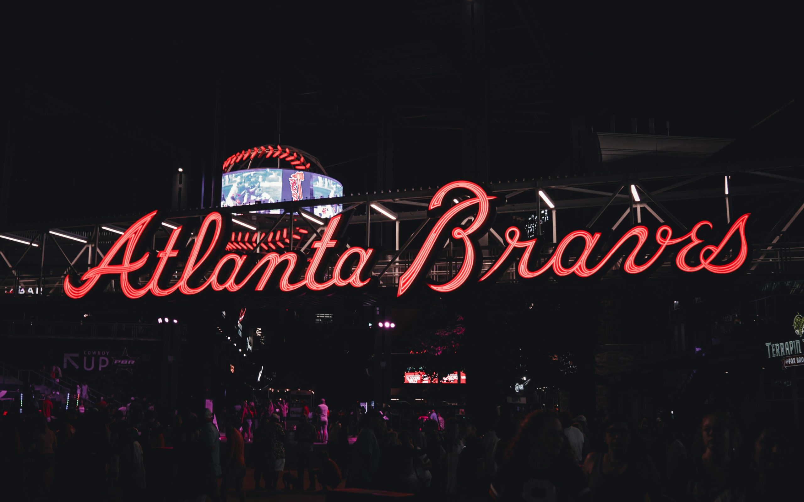 The Atlanta Braves sign lit at night.
