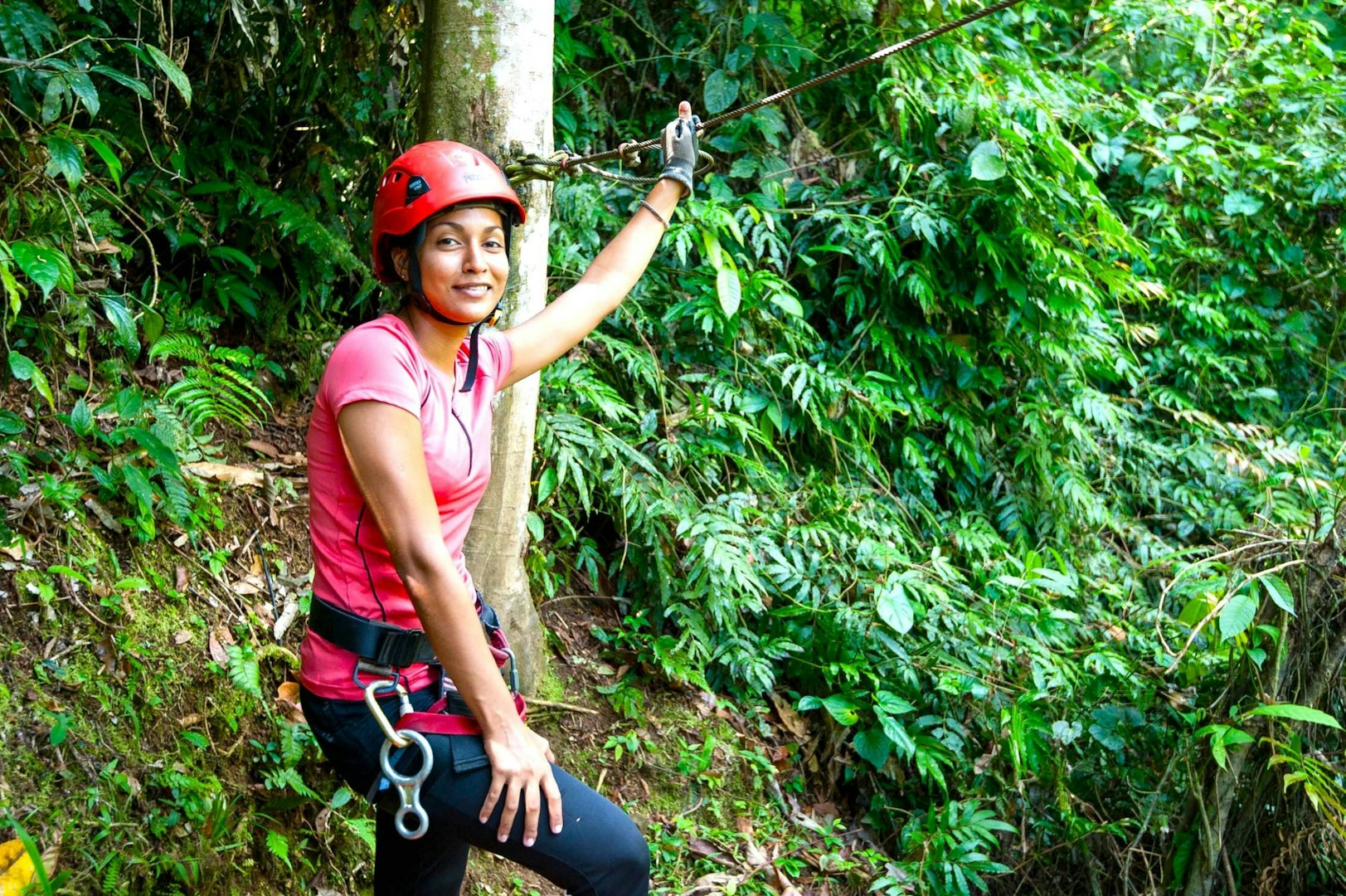 Young woman ready for a zipline adventure through the jungle during her gap year.